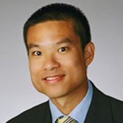Dr. Huang photo Headshot of Dr. Gregory Huang. Dr. Huang is wearing a suit and has short hair.